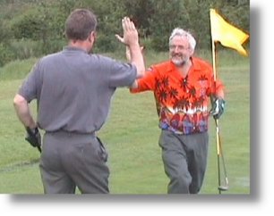 Norrie Smith congratulates BJ after a superb putt during the 2002 Championship